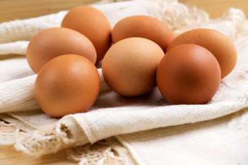 Eggs wrapped in cloth on wood table
