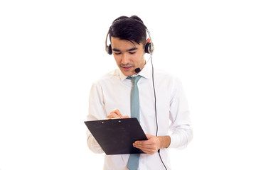 Young man using headphones and holding folder