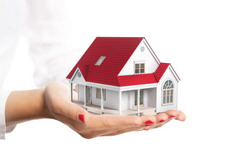 Hands holding a small house isolated on white