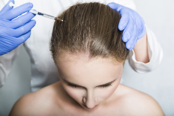 Fototapeta premium Doctor aesthetician makes head beauty injections to female patient