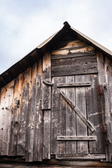 Part old rustic wooden house - an attic with small door.