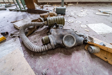 Old glas mask in one of classrooms of abandoned school in Mashevo village, Chernobyl Exclusion...