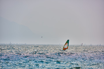 Windsurfer pro-rider surfing at high speed on Lake Garda, italy