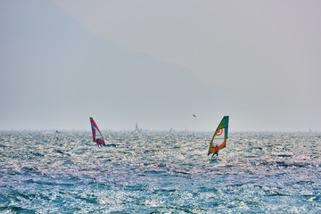 Riva del Garda, Italy (Lago Benaco)- April 14,2017: A Windsurfer pro-rider surfing at high speed on...