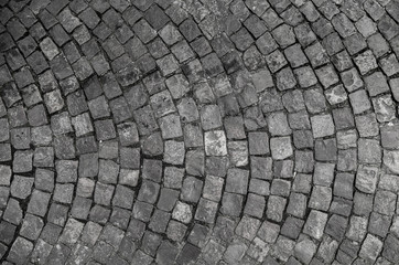 Stone pavement texture. Granite cobble stoned pavement background. Abstract background of old cobblestone pavement close-up