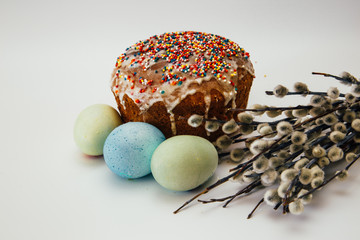Easter composition on a white background - Easter cake, painted eggs, willow branches
