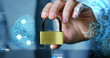 Businessman shows a padlock with security symbol with futuristic holographic about services and safety.Concept of password,Protection system files from technological hacker internet or banking system