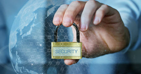 Businessman shows a padlock with security symbol with futuristic holographic about services and safety.Concept of password,Protection system files from technological hacker internet or banking system