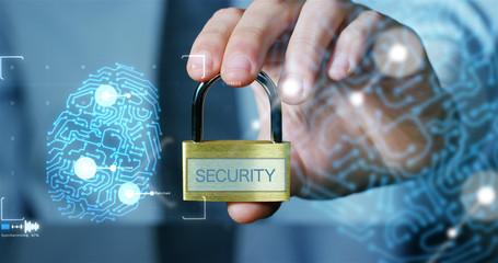Businessman shows a padlock with security symbol with futuristic holographic about services and safety.Concept of password,Protection system files from technological hacker internet or banking system