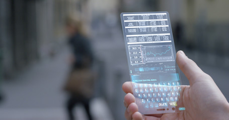 A businessman in the city, use the transparent phone with latest technology security code fingerprint. Concept: technology, business, security and internet banking, future	