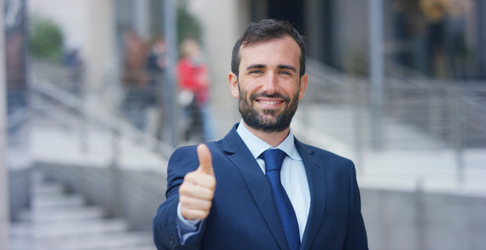 A man in a suit, looks in camera and smiles proud and sure of himself. Concept of politics, business, finance, banking, insurance and testimonials for political campaign.	
