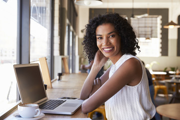Portrait Of Businesswoman Working In Coffee Shop