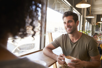 Couple Meeting For Date In Coffee Shop
