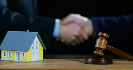 hand shake, auction scene of lawyers or notaries with gavel judge for the insurance compensation or criminal cases. concept of law and lawyer, judiciary and legislature applied to the democratic law.	