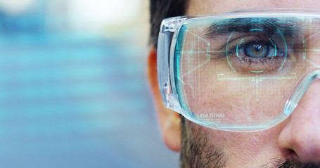 A man with a futuristic look with glasses augmented reality in holography.	