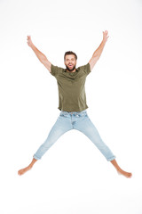 Happy young man jumping isolated over white background