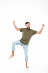 Smiling young man standing isolated over white background.