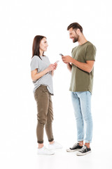 Fototapeta premium Man and woman with smartphones looking at each others