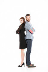 Young offended loving couple standing isolated