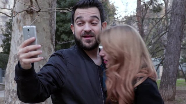 nice couple making  funny selfie at the park,winter time