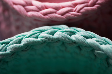 Fototapeta premium Baskets - turquoise and pink crochet around the circle of knitting yarn, made of cloth.Close