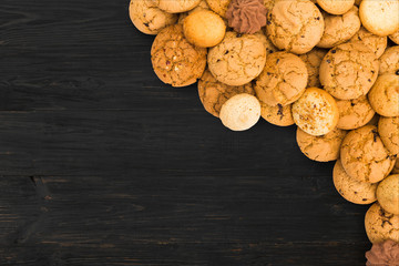 Cookies and biscuits at black wood with copy space
