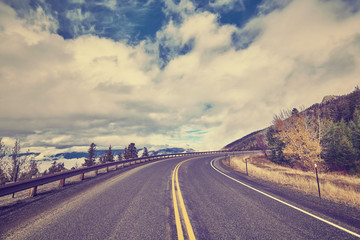 Vintage stylized scenic mountain road, USA.