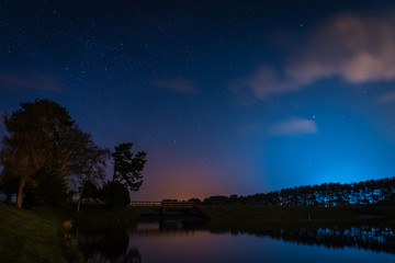 Fototapeta premium Whittle Dene Reservoir at Night / Whittle Dene Reservoir in Northumberland is a popular place for fishing, seen here at night under the stars