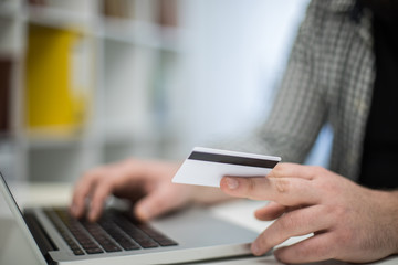 Cropped photo of a man's hand holding credit card