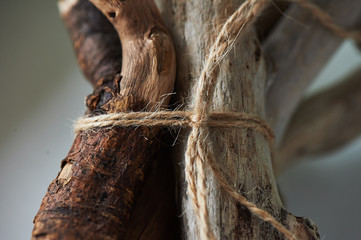 Curves salted sticks, driftwood collected on the beach, on a light background, tied with a rope. Eco