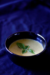 Asparagus soup in a black bowl 