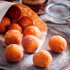 Donuts of cottage cheese in a paper bundle, square