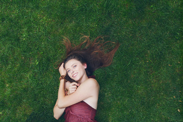 Girl lay on grass, relax in summer park