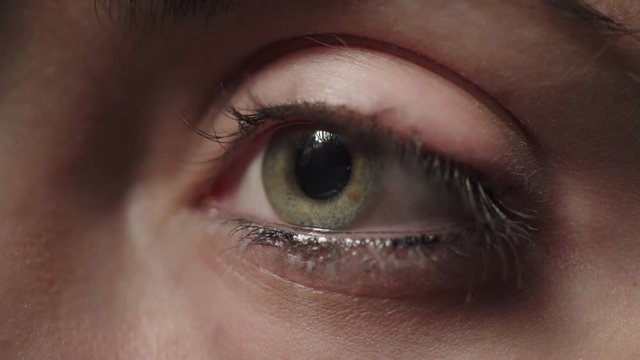 Macro-green woman's eye opens