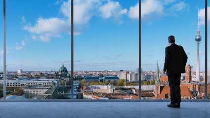 Fototapeta na wymiar Geschäftsmann schaut aus Fenster auf Berlin