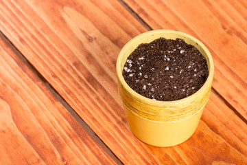 Fototapeta na wymiar Flat lay above flower pot with soil for seeding plants