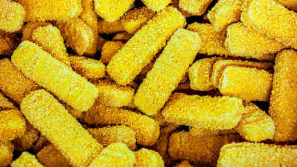 Half-finished fish sticks at frozen shop basket