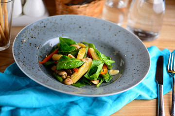 Grilled vegetables. Salad from roasted pepper, ear of corn, French bean and greenery in a plate served for a dinner in a restaurant. Lenten menu. Healthy food concept.