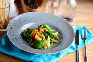 Grilled vegetables. Salad from roasted pepper, ear of corn, French bean and greenery in a plate served for a dinner in a restaurant. Lenten menu. Healthy food concept.