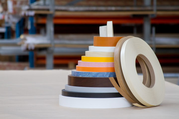 Multicolored bobbins of PVC edge and melanin for the manufacture of furniture. Lie pyramid.