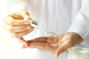 Beauty cosmetics sciences, Formulating and mixing skincare with herbal essence, Scientist testing a new organic beauty products on hand.