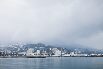Naklejka na ściany i meble The promenade of Yalta. The port in the black sea. Cloudy weather on the black sea. The City Of Yalta- Crimea 