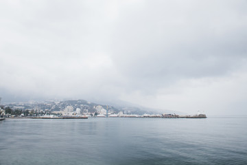 Naklejka na ściany i meble The promenade of Yalta. The port in the black sea. Cloudy weather on the black sea. The City Of Yalta- Crimea 