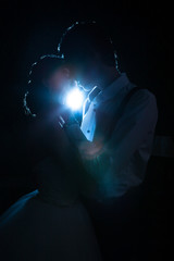 Beautiful inlove bride and groom backlit with blue light. Happiness and marriage