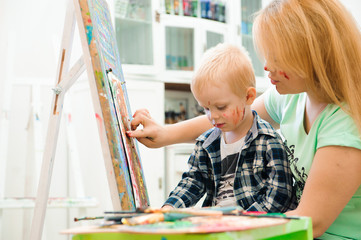 Mother and child draw a picture paints, art lesson