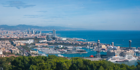 Fototapeta na wymiar Beautiful Blue commerce. Coastline of Spain in seaside Barcelona. Modern city scape & coastline as seen from high level, cable car over the city. 