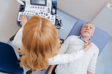 Proficient medic providing ultrasonic body monitoring at work