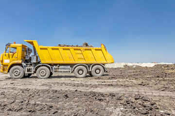 Obraz premium Dumper truck is going backward to unload soil