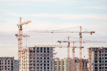 Fototapeta premium Building crane and buildings under construction