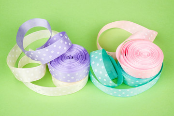 Closeup of ribbon roll over colorful background